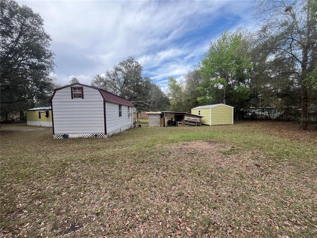 10330 Northeast 90th Street Bronson, FL 32621 - Photo 28 of 31 a view of a tiny house with a yard