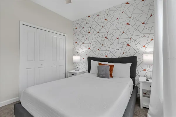 a bedroom with a bed and a chandelier