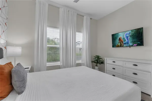 a bedroom with a bed and a couch