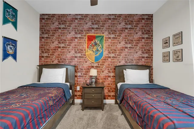 a bedroom with a large bed and a painting on the wall