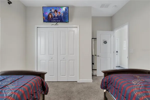 a bedroom with a large bed and a chandelier
