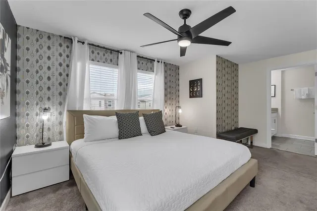 a bedroom with a bed a desk and chair