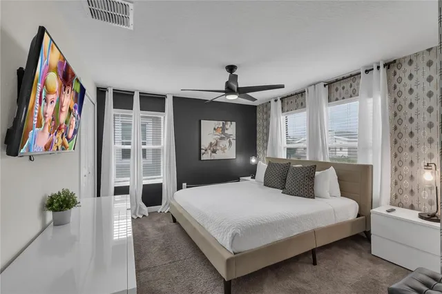 a large bed sitting in a bedroom and a chandelier