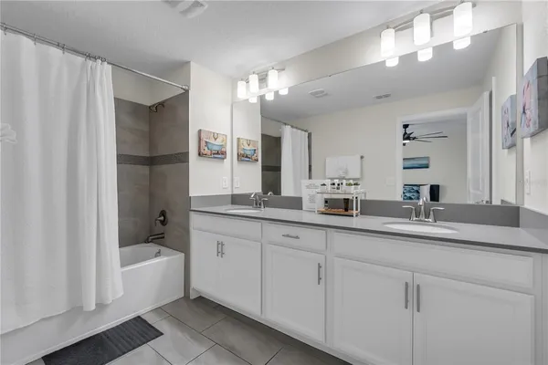 a bathroom with a granite countertop sink toilet and a mirror