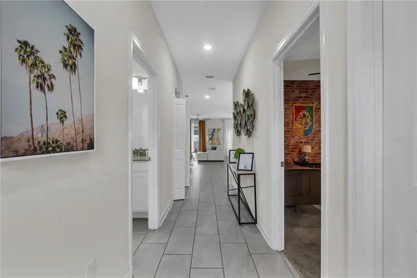 a kitchen with stainless steel appliances granite countertop a sink a stove a refrigerator and a dining table with wooden floor