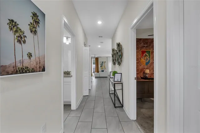 a kitchen with stainless steel appliances granite countertop a sink a stove a refrigerator and a dining table with wooden floor