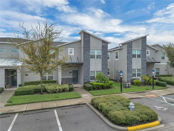 a very nice looking open dining room with kitchen island furniture a chandelier a large window and kitchen view