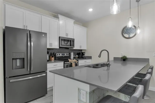 a kitchen with a sink appliances and cabinets