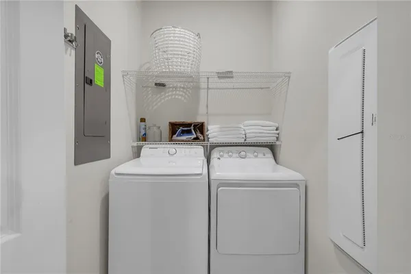 a view of a dining room with furniture a chandelier and wooden floor