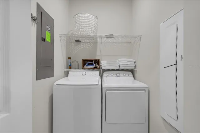 a view of a dining room with furniture a chandelier and wooden floor