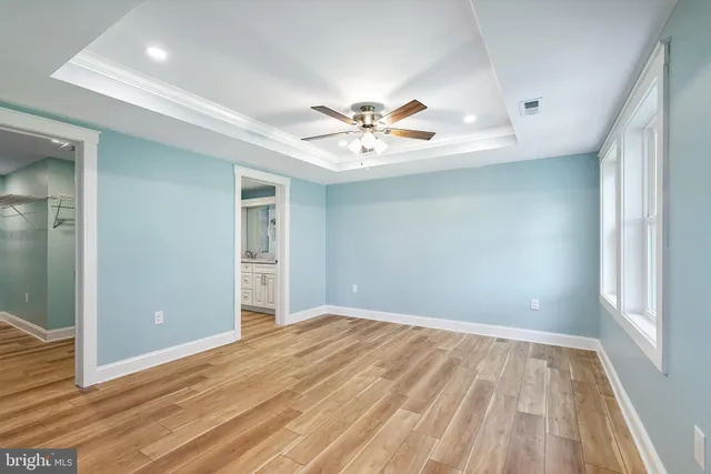 a spacious bathroom with a double vanity sink a large mirror and a shower