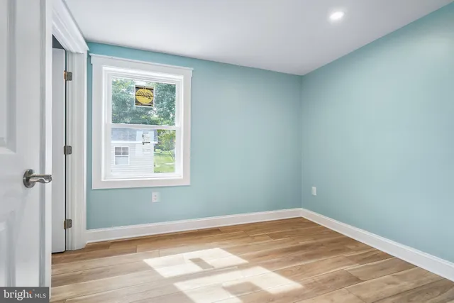 a bathroom with a granite countertop toilet sink and mirror
