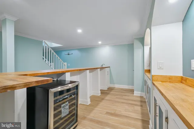a view of a room with wooden floor and a bathroom