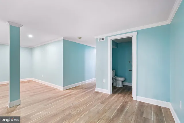 a view of a room with wooden floor