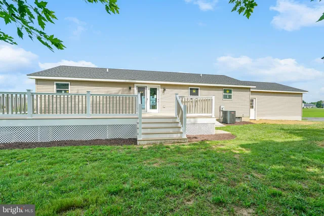 a view of backyard with a deck and wooden floor