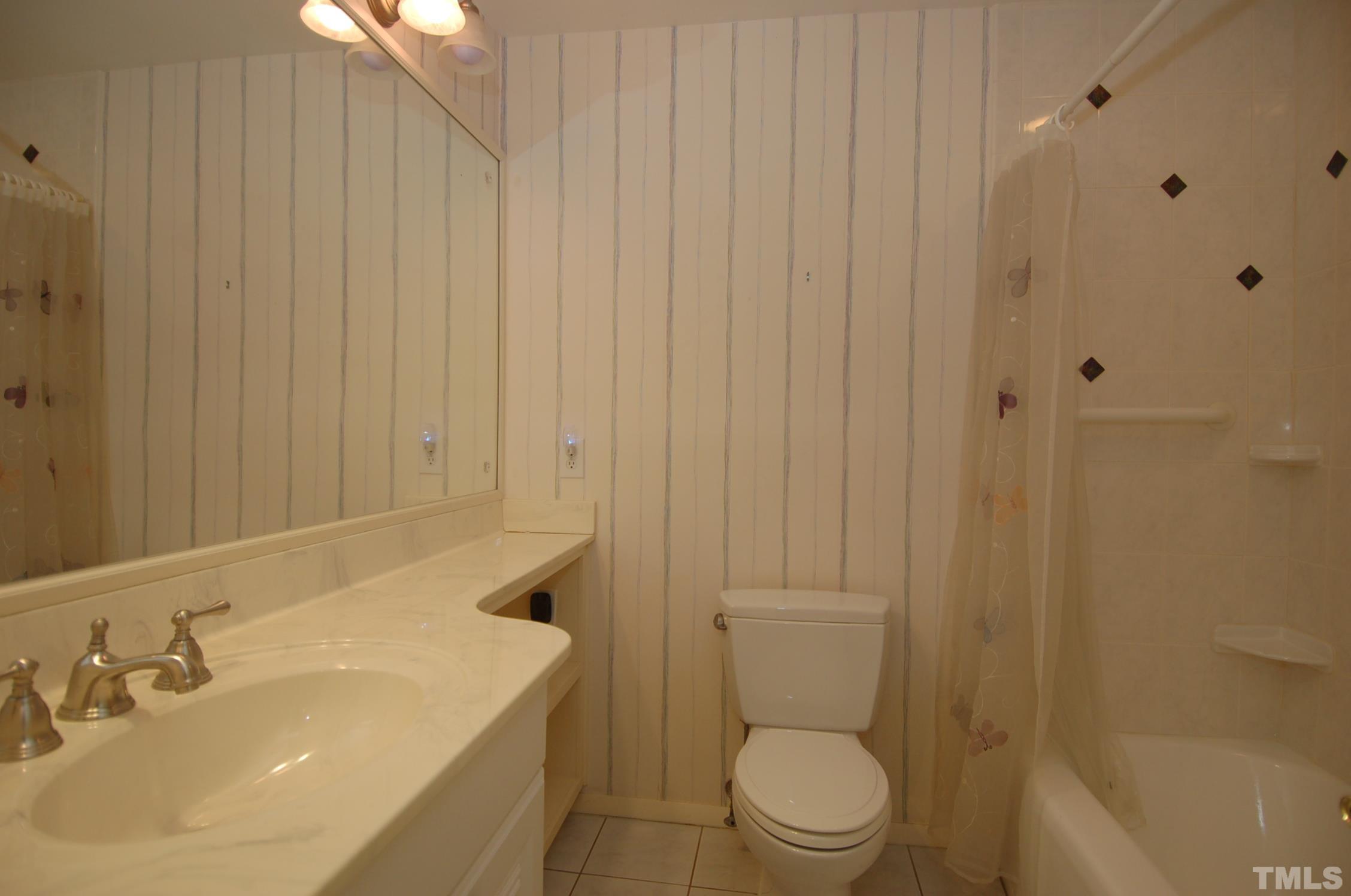 1113 Dogwood Lane Raleigh, NC 27607 - Photo 12 of 14 a bathroom with a sink a toilet and shower