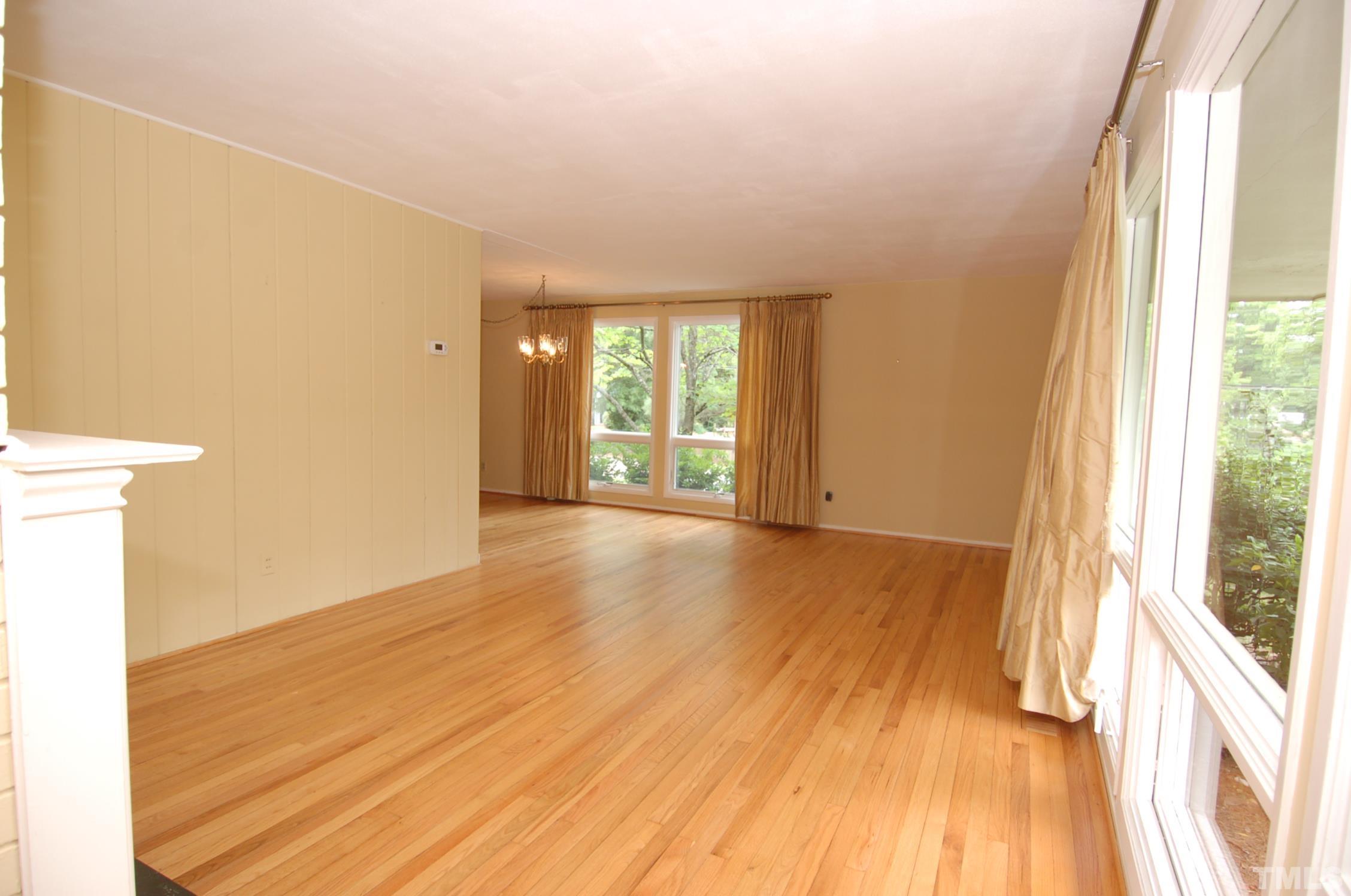 1113 Dogwood Lane Raleigh, NC 27607 - Photo 2 of 14 a view of an empty room with wooden floor and a window