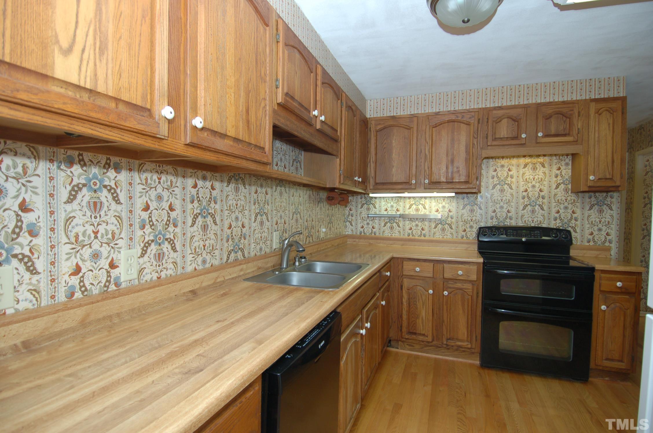 1113 Dogwood Lane Raleigh, NC 27607 - Photo 4 of 14 a kitchen with a sink and cabinets