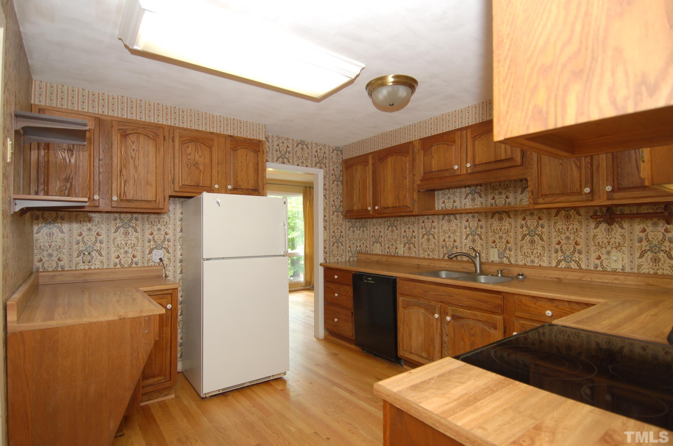 1113 Dogwood Lane Raleigh, NC 27607 - Photo 5 of 14 a kitchen with a refrigerator and a sink