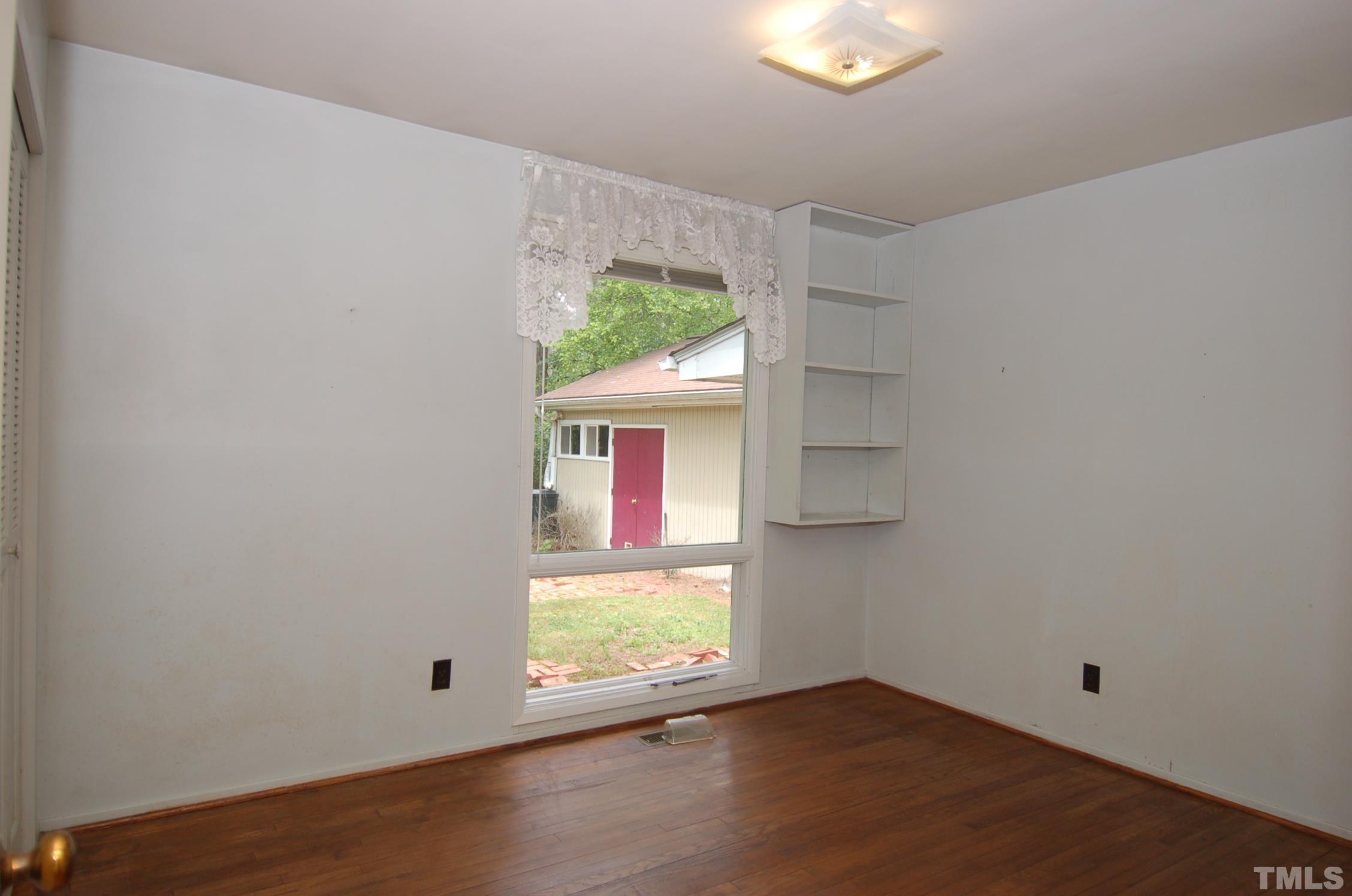 1113 Dogwood Lane Raleigh, NC 27607 - Photo 8 of 14 an empty room with a window