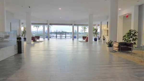 a lobby with furniture and floor to ceiling window