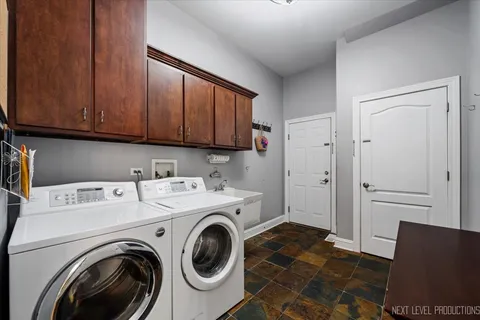 a view of storage and utility room with washer and dryer