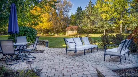 a view of a patio with table and chairs and potted plants