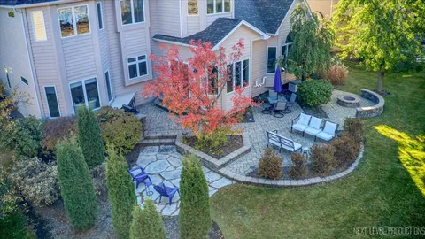 a view of a house with a yard and potted plants