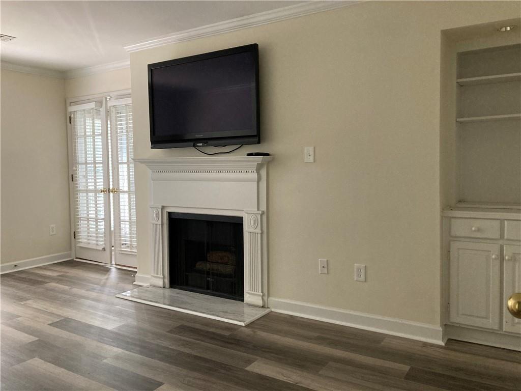 3203 Lenox Road Northeast, Unit 6 Atlanta, GA 30324 - Photo 9 of 27 a living room with a fireplace and a flat screen tv
