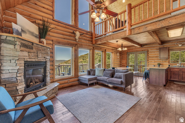 2348 North Miles Holw Road, Unit 26 Kamas, UT 84036 - Photo 5 of 31 Living area featuring french doors, log walls, ceiling fan, a high wood ceiling, and dark wood-style flooring