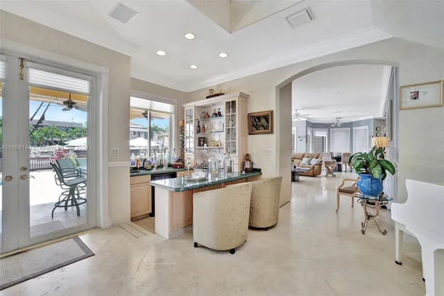 a kitchen with stainless steel appliances granite countertop a stove top oven a refrigerator a sink and white cabinets