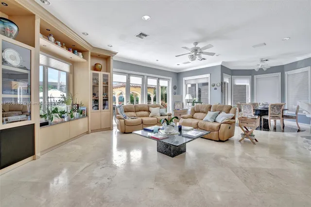 a view of a livingroom with furniture wooden floor and windows