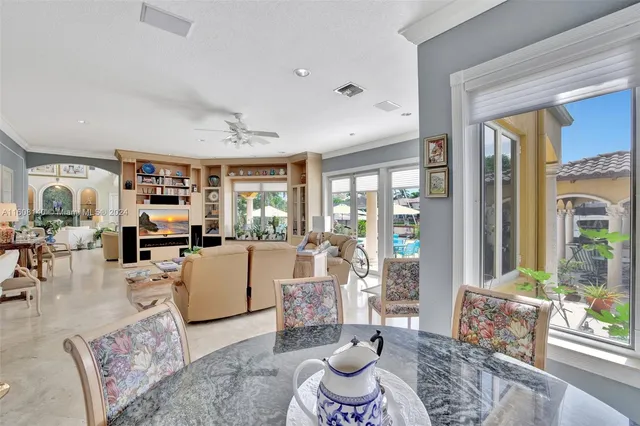 a large white kitchen with white cabinets and stainless steel appliances