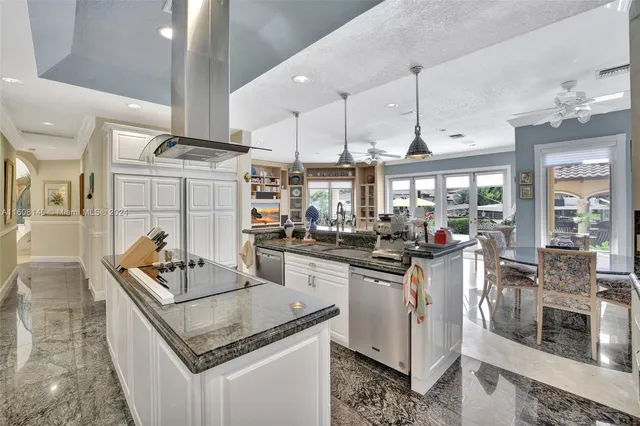 a bathroom with a granite countertop sink vanity mirror bathtub and toilet