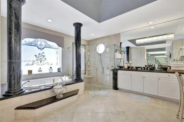 a view of a dining room with furniture a chandelier and large windows