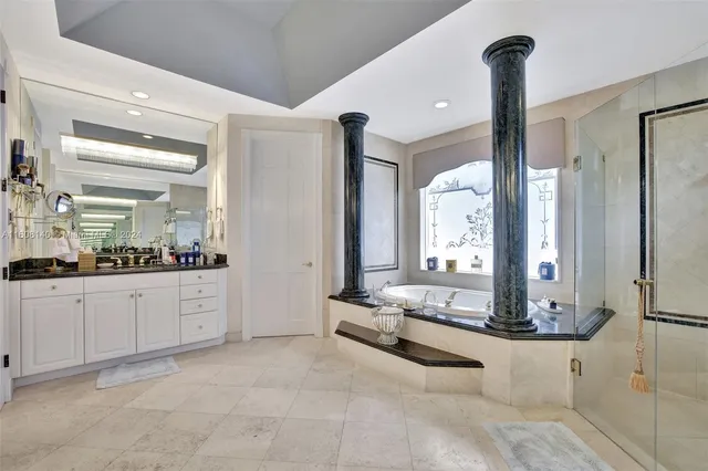 a front view of a multi story building with yard and outdoor seating