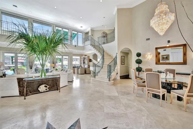 a living room with furniture fireplace and a large window
