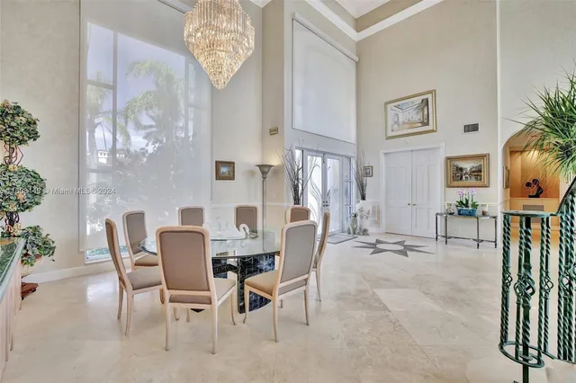 a living room with furniture a fireplace and a potted plant