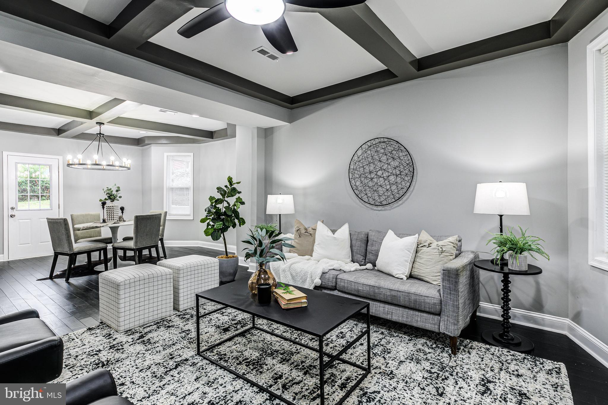 5011 Catalpha Road Baltimore, MD 21214 - Photo 11 of 42 a living room with furniture a chandelier and a table