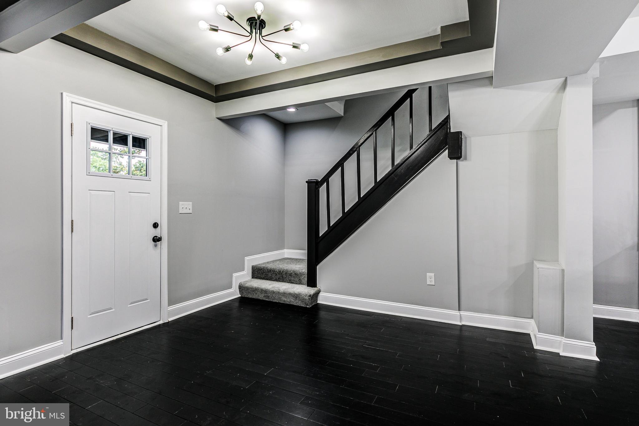 5011 Catalpha Road Baltimore, MD 21214 - Photo 13 of 42 a view of entryway and hall with wooden floor