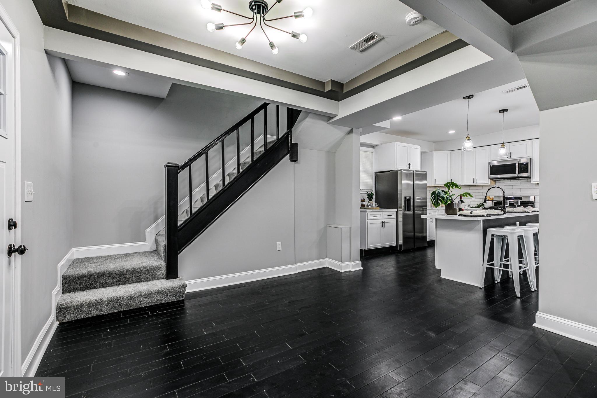 5011 Catalpha Road Baltimore, MD 21214 - Photo 15 of 42 a view of a livingroom with kitchen and furniture