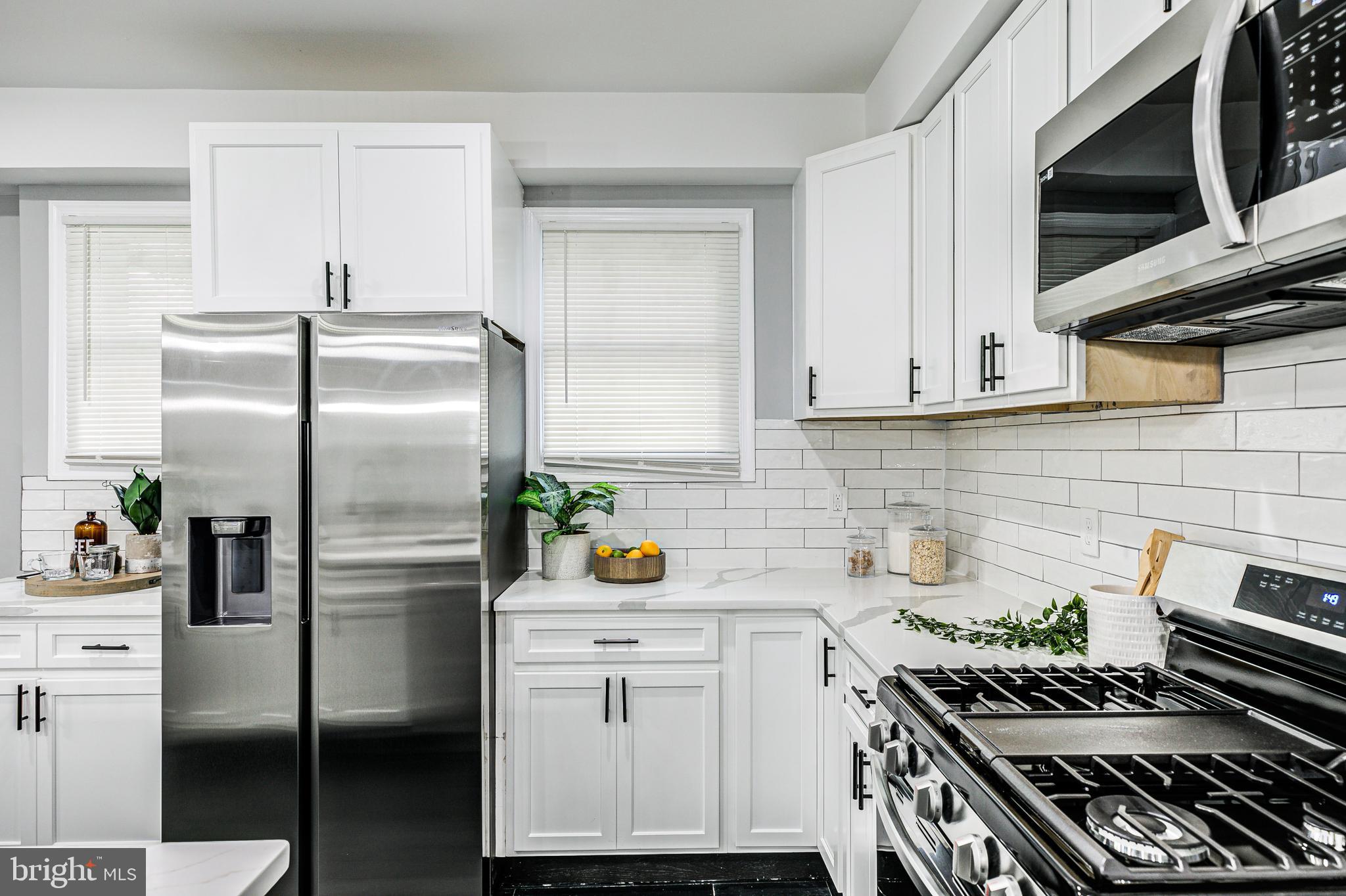 5011 Catalpha Road Baltimore, MD 21214 - Photo 19 of 42 a kitchen with stainless steel appliances a stove a refrigerator and a cabinets