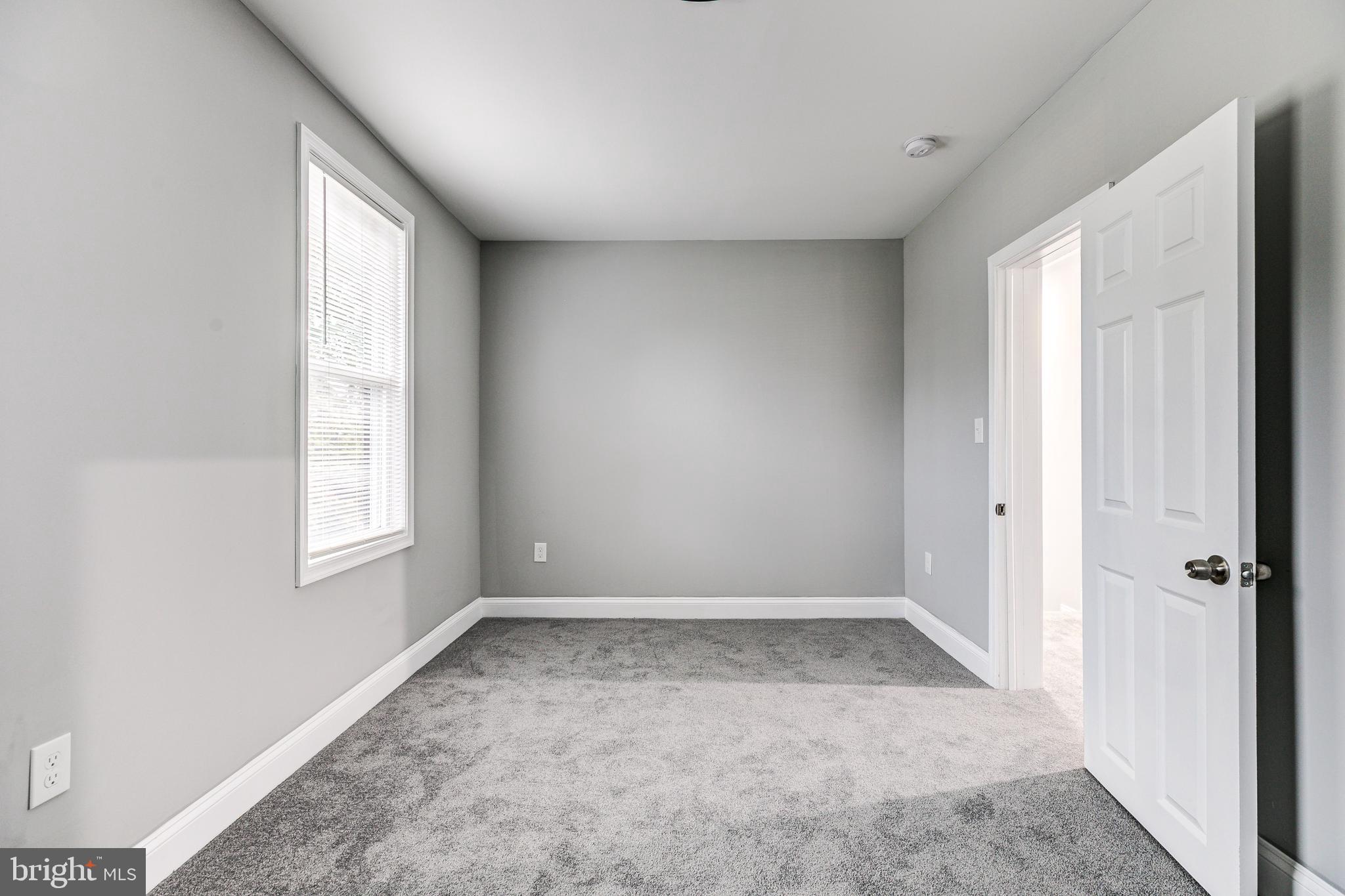 5011 Catalpha Road Baltimore, MD 21214 - Photo 32 of 42 a view of an empty room with a window