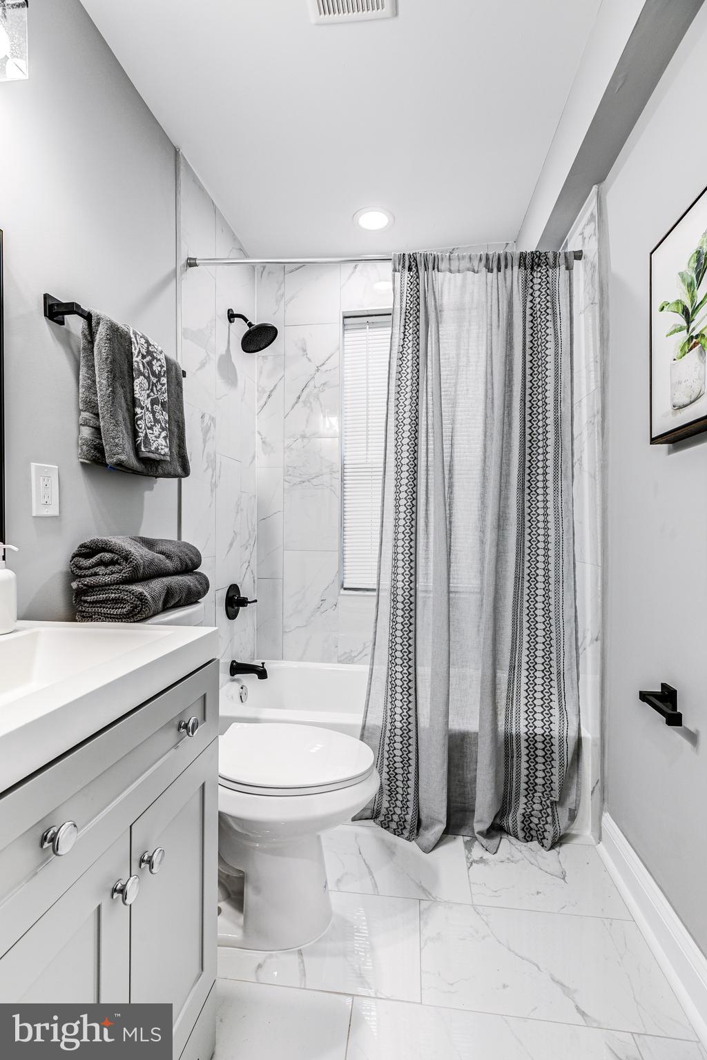5011 Catalpha Road Baltimore, MD 21214 - Photo 34 of 42 a bathroom with a sink toilet and shower