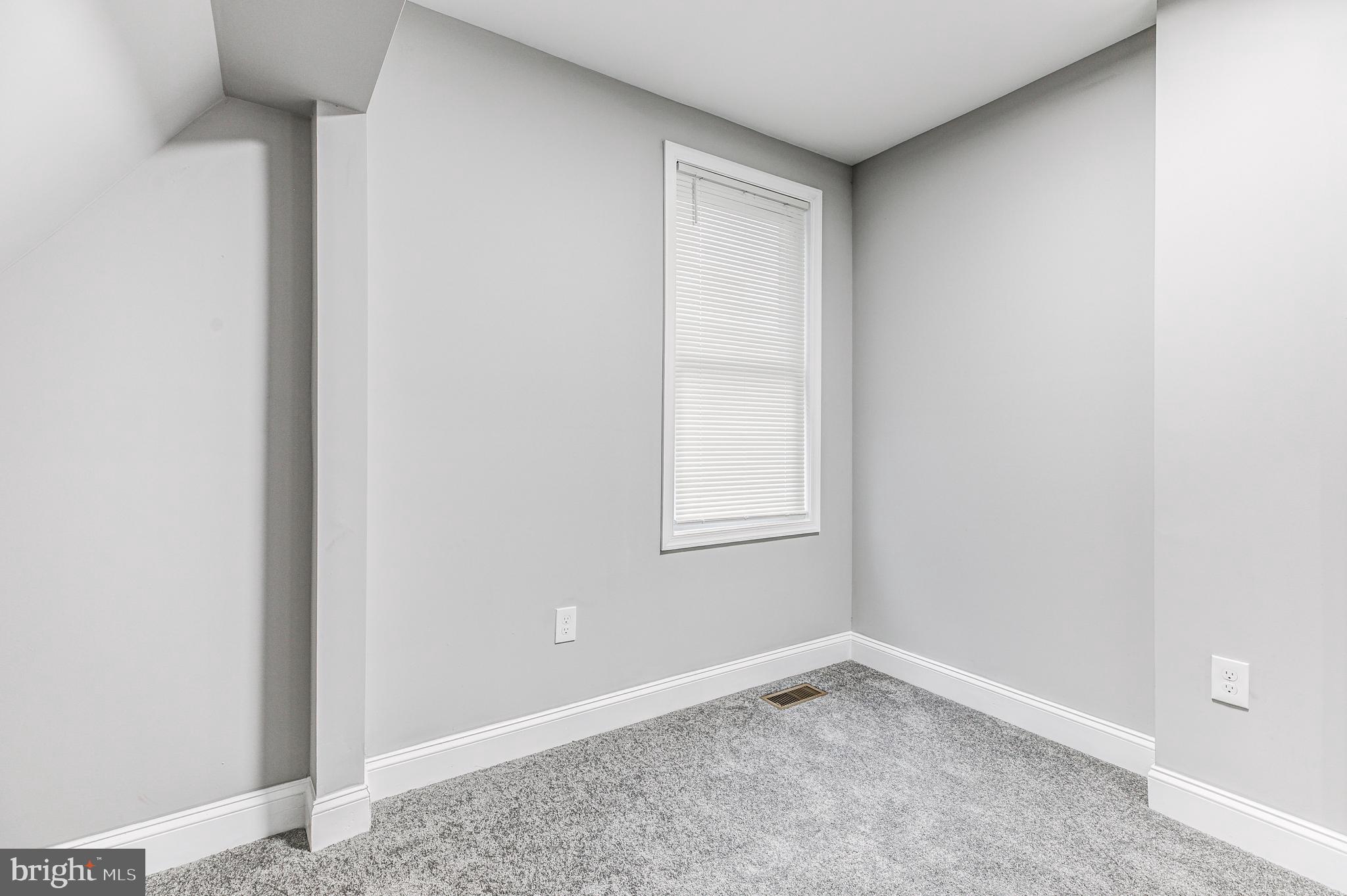 5011 Catalpha Road Baltimore, MD 21214 - Photo 36 of 42 an empty room with a window