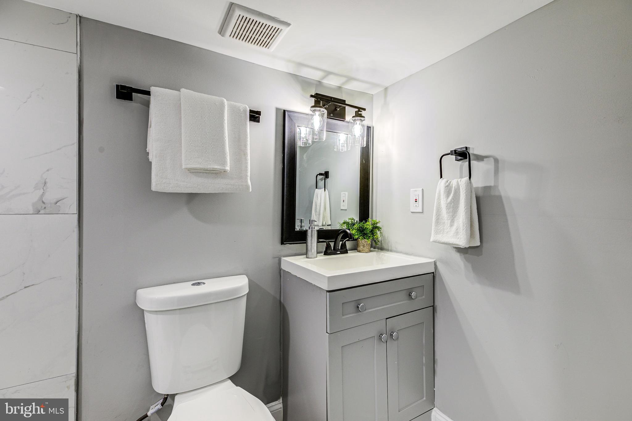 5011 Catalpha Road Baltimore, MD 21214 - Photo 39 of 42 a bathroom with a sink toilet and shower