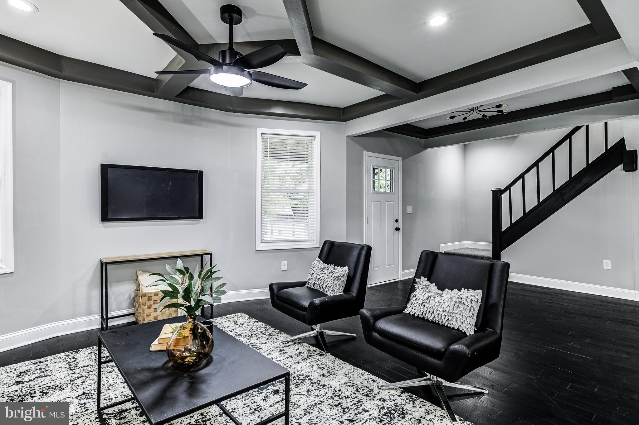 5011 Catalpha Road Baltimore, MD 21214 - Photo 8 of 42 a living room with furniture and a flat screen tv