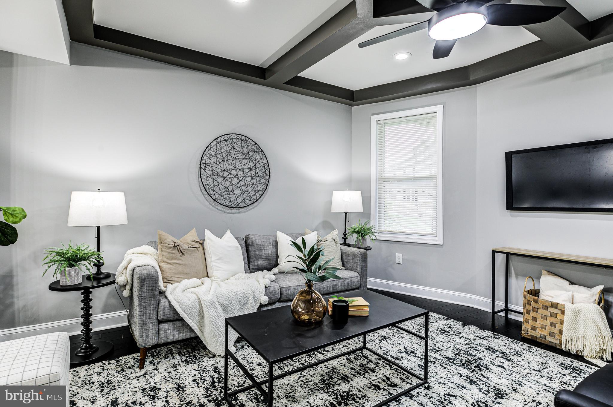 5011 Catalpha Road Baltimore, MD 21214 - Photo 9 of 42 a living room with furniture and a flat screen tv