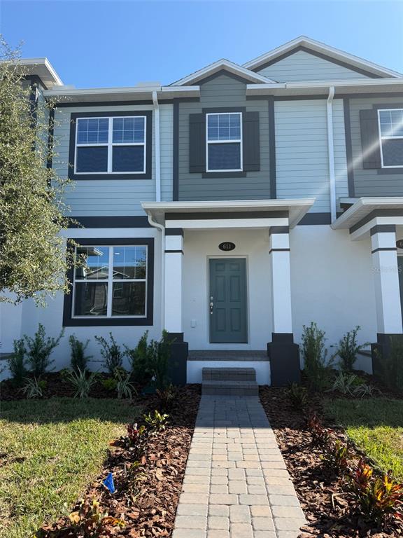 611 Pothos Street Apopka, FL 32703 - Photo 1 of 34 a front view of a house with a yard