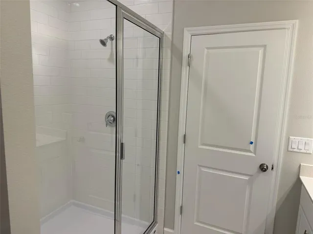 a bathroom with a glass shower door
